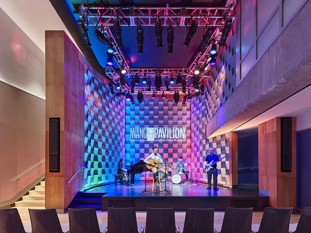 A band plays on the Wang Pavilion stage, which is illuminated with different colorful lights.