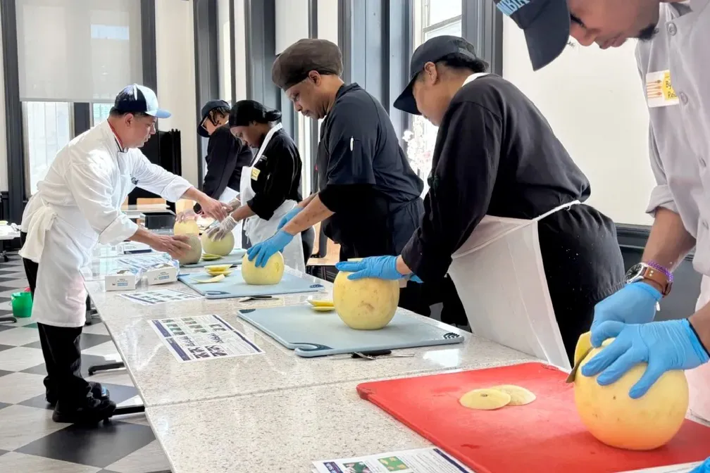 Chef Mike trains Columbia Dining staff how to cut melons.