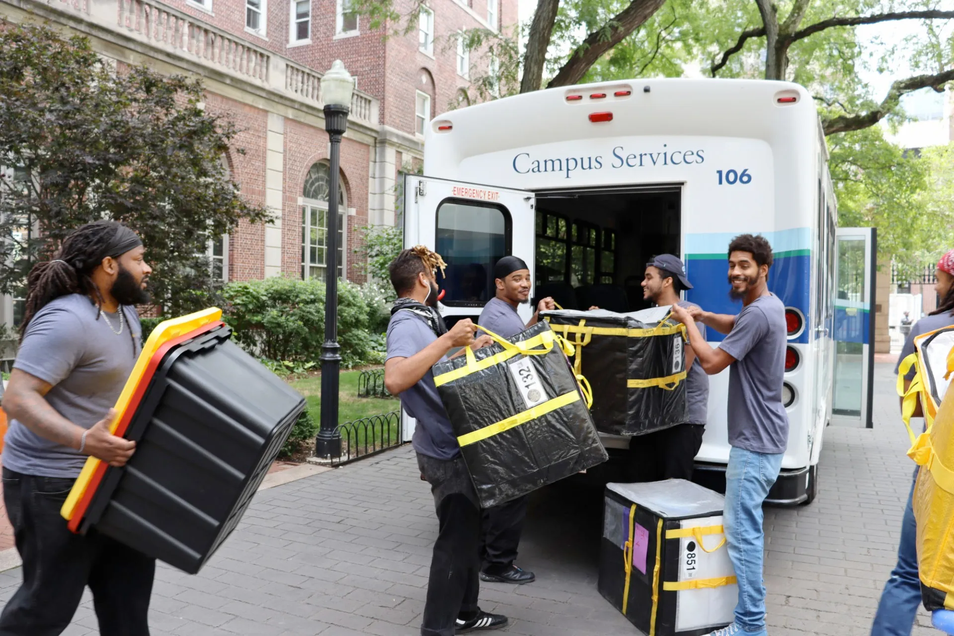 Columbia Mail loads packages onto a Campus Services bus for delivery.