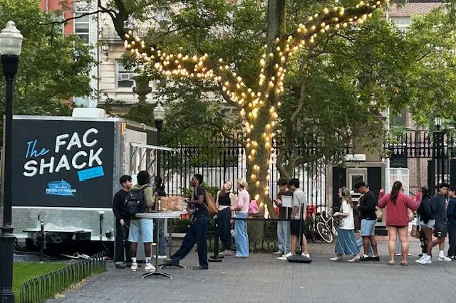A line of customers are lined up at The Fac Shack, a food truck in Wien Courtyard.