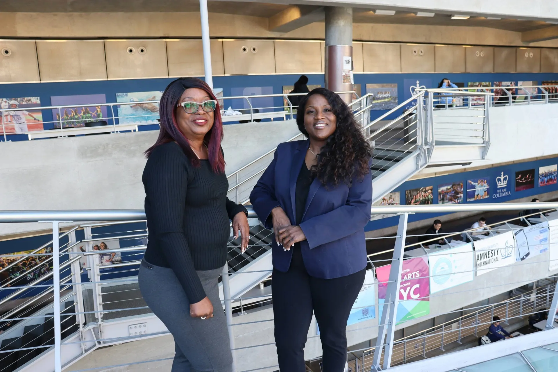 Tammie Steward and Nakia Howell-Spears stand against a banister in Lerner Hall.