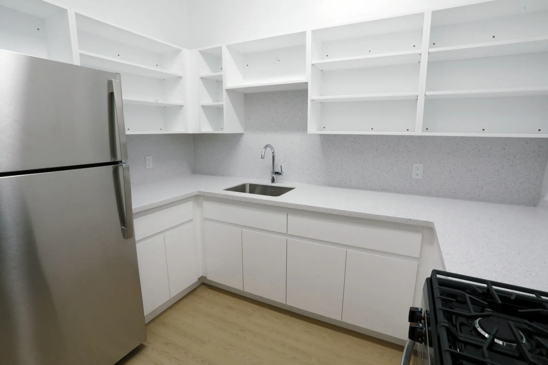 A newly refreshed kitchen in Hogan Hall white cupboards.