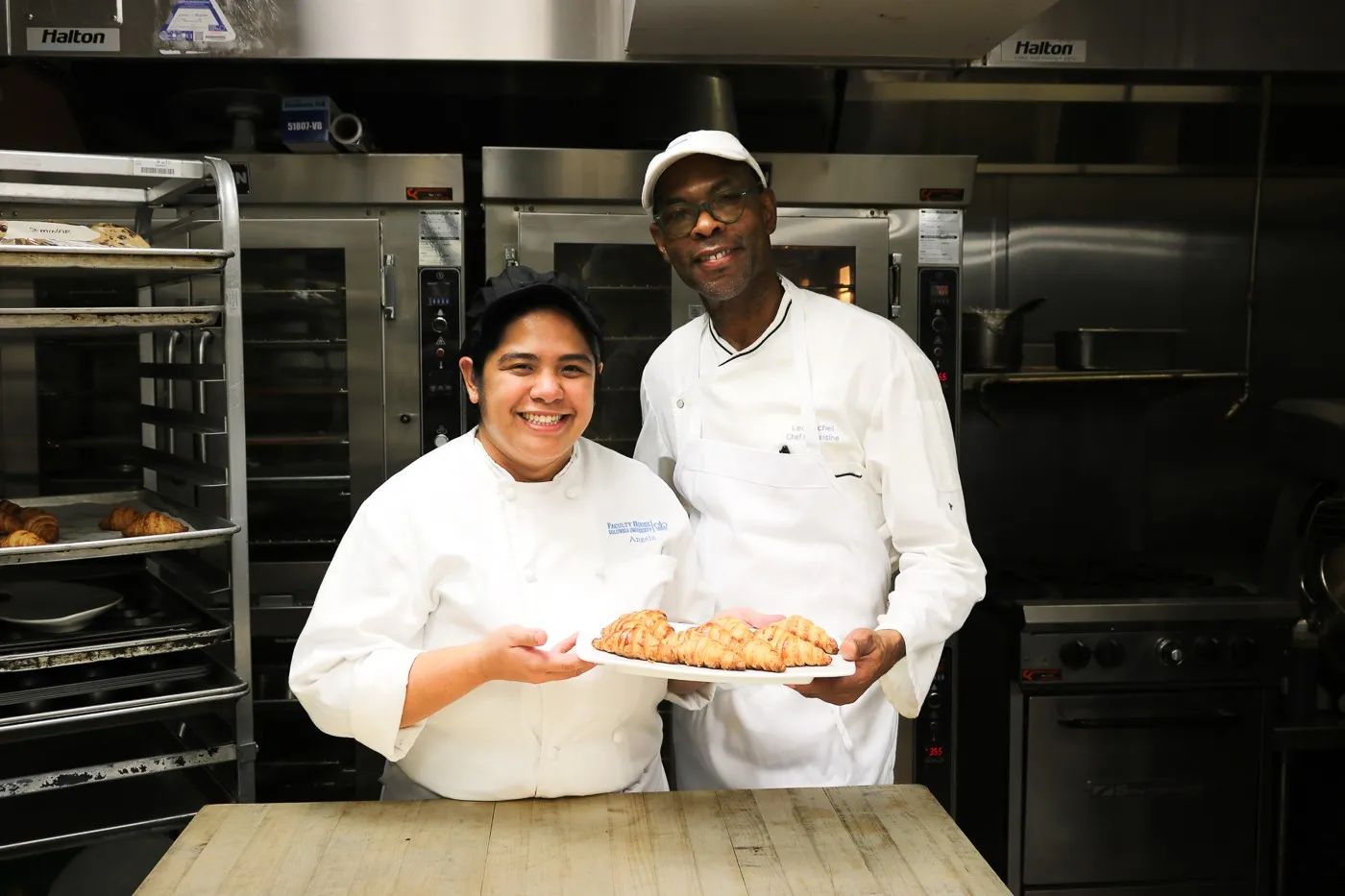 Chef Leo Michel and Rounds Cook Angela Acorita pose with freshly baked croissants.